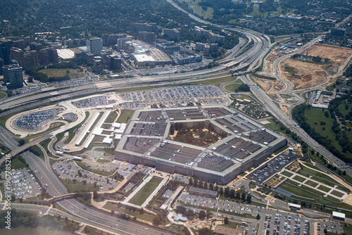 Aerial view of the Pentagon complex with surrounding roads, parking and greenery. g.