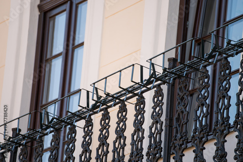 Bild auf Leinwand a wrought iron balcony railing, often featuring intricate, decorative metalwork designed to enhance residential or commercial architectural facades