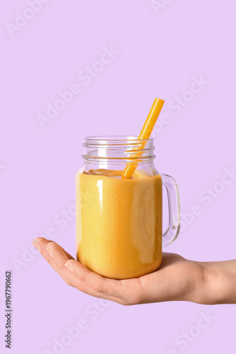 Female hand with Mason jar ...