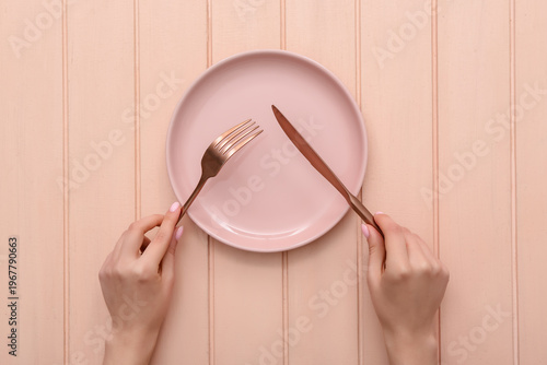 Female hands with cutlery a...