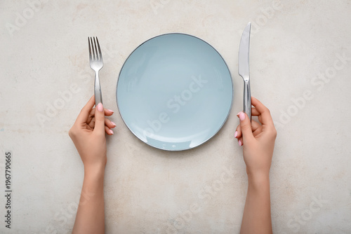 Female hands with cutlery a...