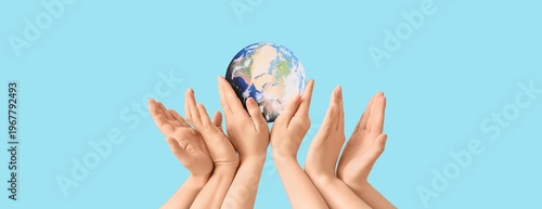 Many hands holding model of...