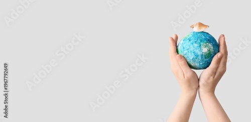 Hands holding model of Eart...