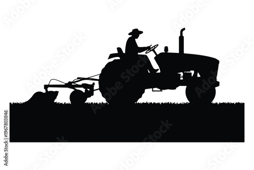 Silhouette of man driving tractor with mower attachment