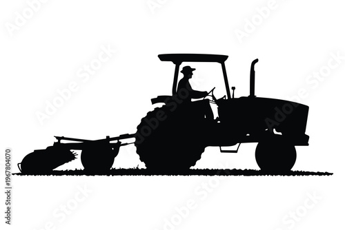 Silhouette of man driving tractor with plow driver