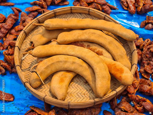 Tamarind, a tropical fruit with a sweet and sour taste, is used as an ingredient in cooking.