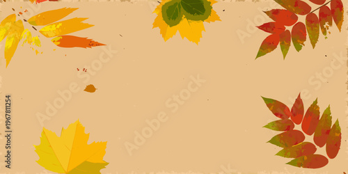 Autumn leaves in shades of red yellow and green scattered on beige