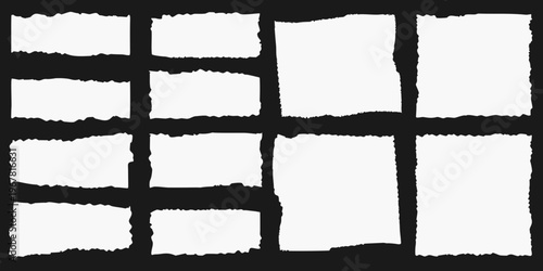 Arrangement of torn white paper pieces on a black background