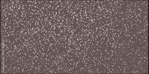 A close up view of a textured mottled brown and white surface