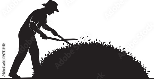 Man in hat shoveling pile of grass