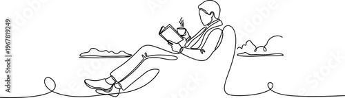 Man sitting on a surfboard reading.