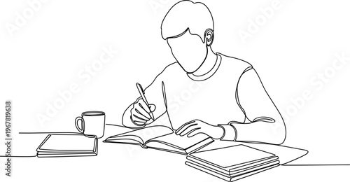 Man sitting at desk writing book.