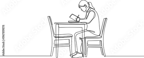 Woman sitting at a table reading.
