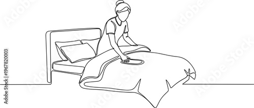 woman making bed in morning routine.