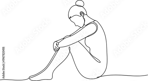 Sad young woman sitting alone.