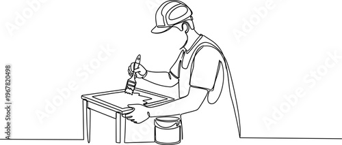 Man wearing cap working with drill.