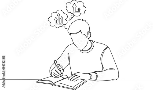 Young man writing in notebook.