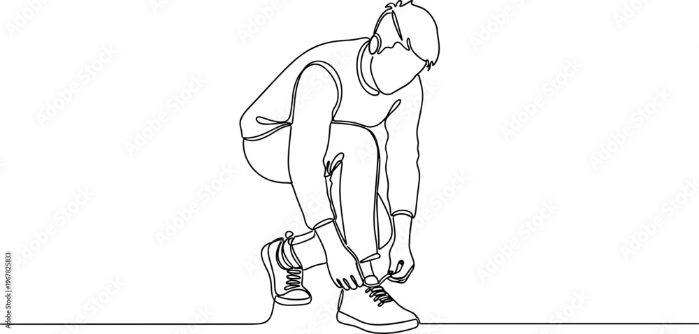 Fototapeta premium Man tying his running shoe laces.