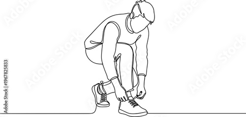 Man tying his running shoe laces.