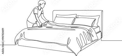 Person making a bed with sheets.