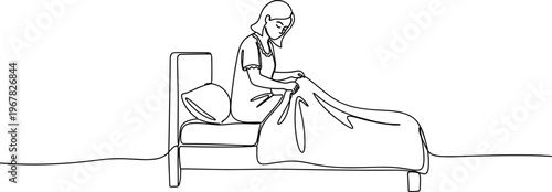 Woman sitting on a bed reading.