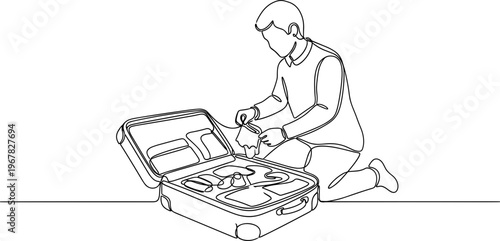 Man kneeling with open suitcase luggage.