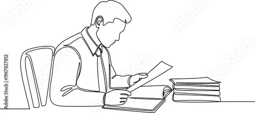 Man sitting at desk with papers.
