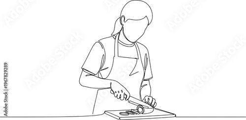 Woman cutting food on a board.
