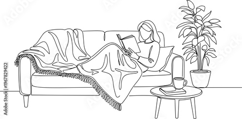 Woman Relaxing on Sofa Reading Book.