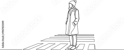 Person standing on crosswalk alone.