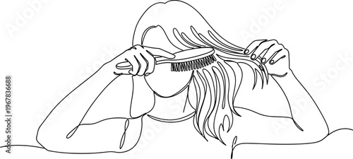 Woman brushing her long hair.