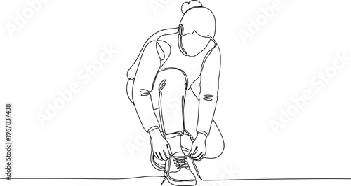 Man tying his shoelaces on ground.