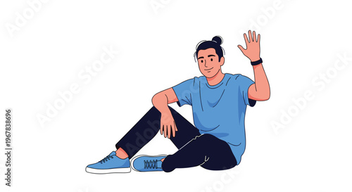 Friendly young man in a casual blue t-shirt and black pants sitting on the ground and waving with a big smile on his face.