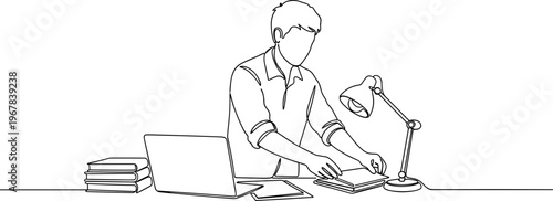 Man working on laptop computer desk.