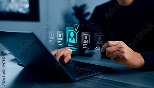 Person using a laptop to search for employees, with holographic icons of candidate profiles and a magnifying glass, symbolizing human resources and recruitment.