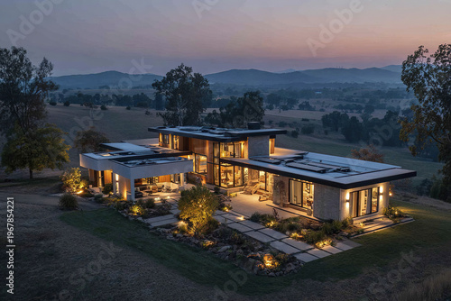 Modern luxury countryside residence with warm interior lighting at twilight, surrounded by trees and rolling hills, showcasing sleek architecture and peaceful rural landscape