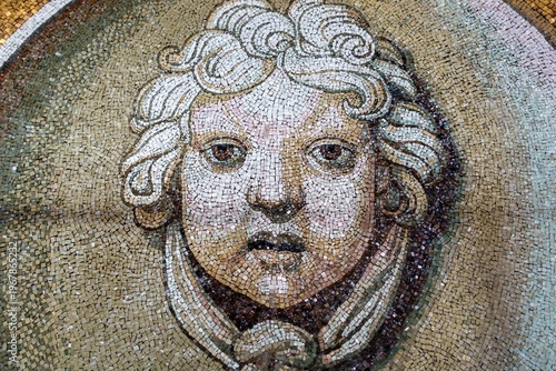 Historical Mosaic Depicting Angel Face, Famous St. Peter Basilica Decorative Mural Detail Front View in Vatican City, Rome Italy