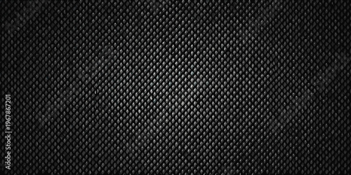 Close up of a dark textured surface resembling woven carbon fiber