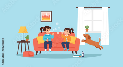 Two young sisters sitting on a red sofa and blowing soap bubbles while their pet dog jumps happily in a cozy living room at home.