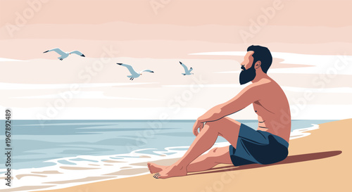 Bearded man sits peacefully on a sandy beach and looks out at the ocean while seagulls fly across a soft sunset sky.