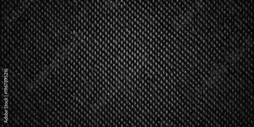 A close up view of a dark textured woven carbon fiber material