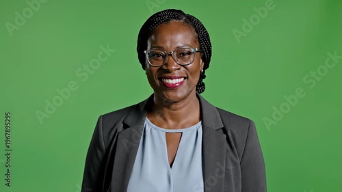 Confident professional woman smiling in formal business attire against green screen