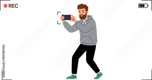 Man recording video with smartphone in hand standing sideways