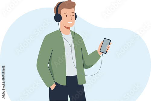Young man wearing headphones listens to music on smartphone