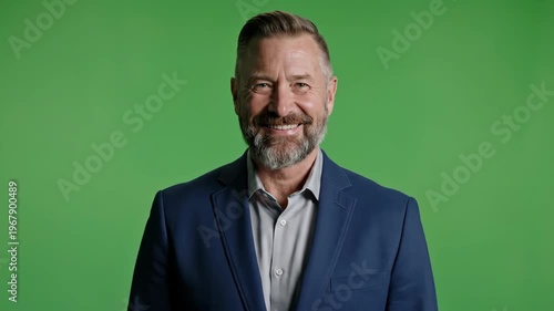 Professional businessman with a confident smile against green background
