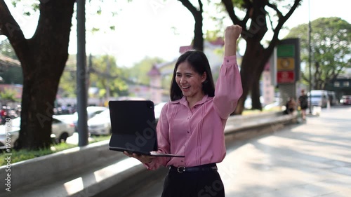 Young businesswoman working remotely on laptop outdoors, enjoying freedom, travel lifestyle, mountain views, productivity, and successful modern career in nature.

