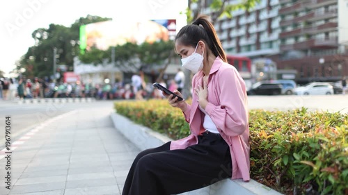 Person wearing mask in toxic urban air, monitoring pollution levels on device, highlighting health risks, environmental hazards, smog, and city pollution concerns.
