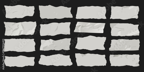 Collection of torn white paper scraps against a black background