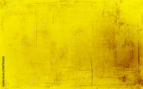 A wall with a rough, textured surface. The wall is yellow and has a lot of dirt and grime on it