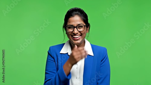 Confident professional woman smiling in vibrant blue blazer against green background